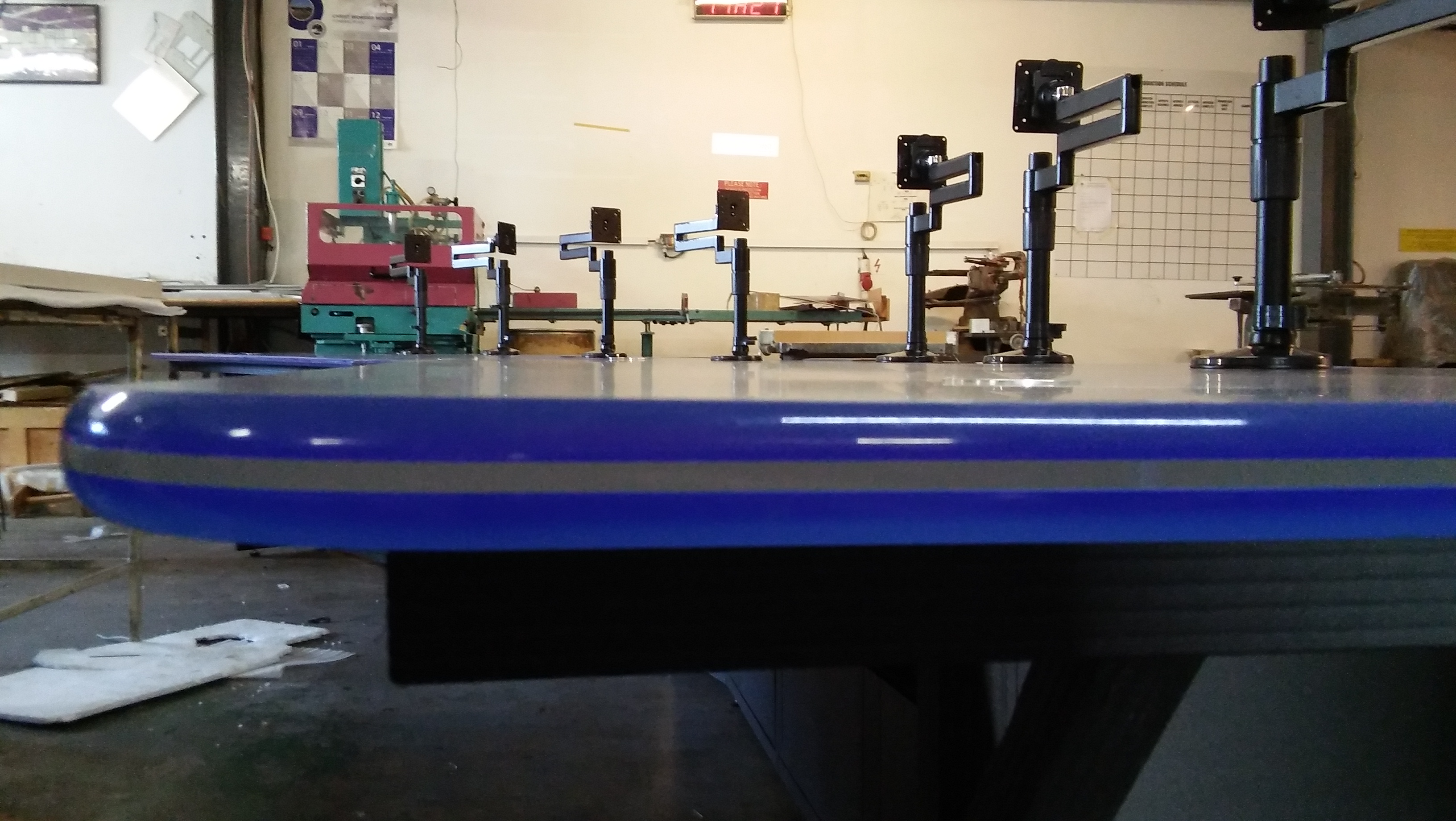 Multi-operator monitor desk with several monitor arms for desk-mount screens by Mimic Components